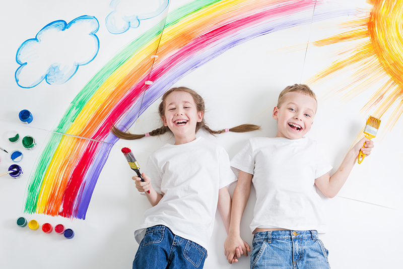 Kinder haben Regenbogen, Wolken und die Sonne gemalt (AdobeStock_107651401)