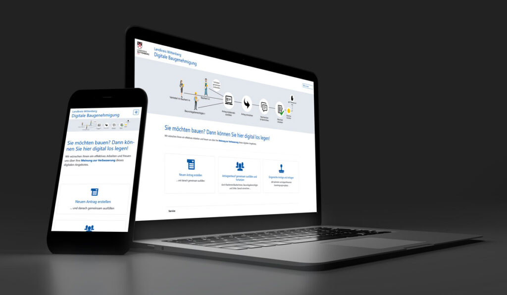 Laptop und Smartphone mit der Webseite vom Bauportal Landkreis Wittenberg