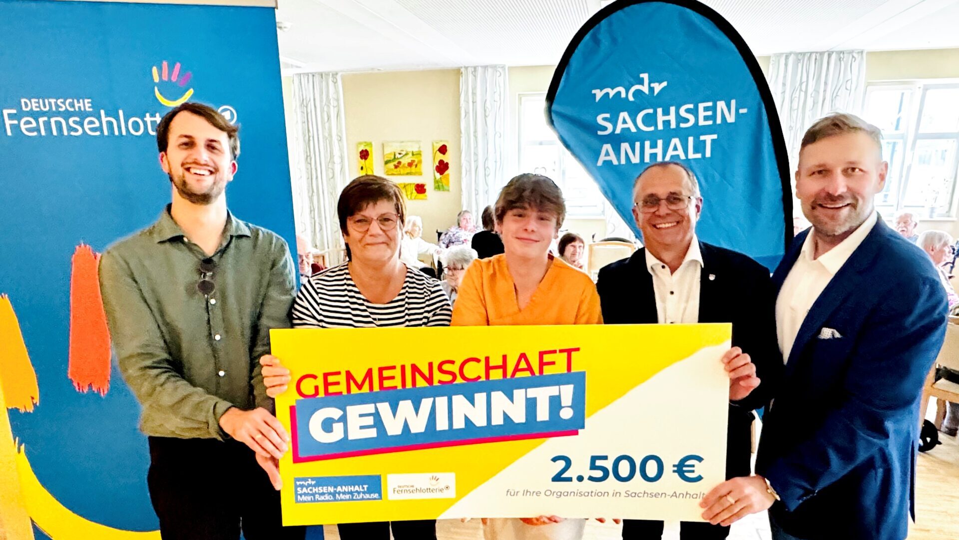 Schulleiter Pascal Rath, Carmen Apelt, Vorstandsmitglied des Fördervereins der Ganztagsschule „Ernestine Reiske“; Alex Brunk, ehemaliger Schüler der Ganztagsschule undaktuell Praktikant in der AWO-Seniorenresidenz ´Marie Juchacz`, Dr. Jörg Hartmann, stellvertretender Landrat des Landkreises Wittenberg & Stephan Masch, Repräsentant der Deutschen Fernsehlotterie bei der symbolischen Scheckübergabe der Gewinnsumme in Kemberg.