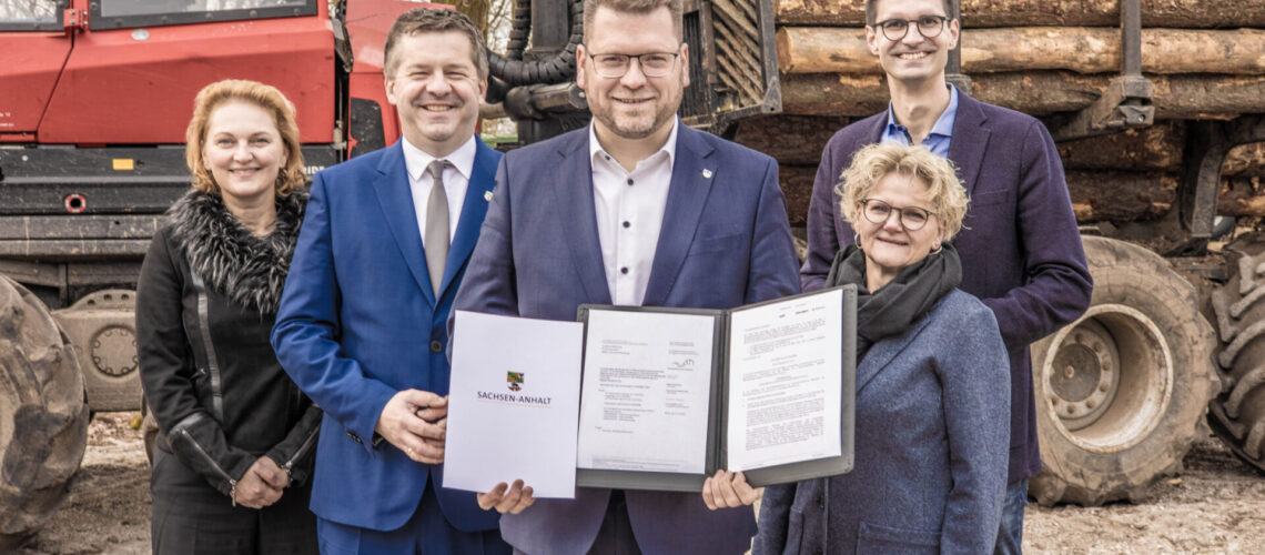 Ministerpräsident Sven Schulze und Bundestagsabgeordneter Sepp Müller überbrachten im Forstbetrieb von Burkhard Schröter die Fördermittelbescheide für den Breitbandausbau im ländlichen Raum an den Landrat Christian Tylsch, der damit in Coswig, Lutherstadt Wittenberg und Kemberg arbeiten wird. Foto: Baumbach