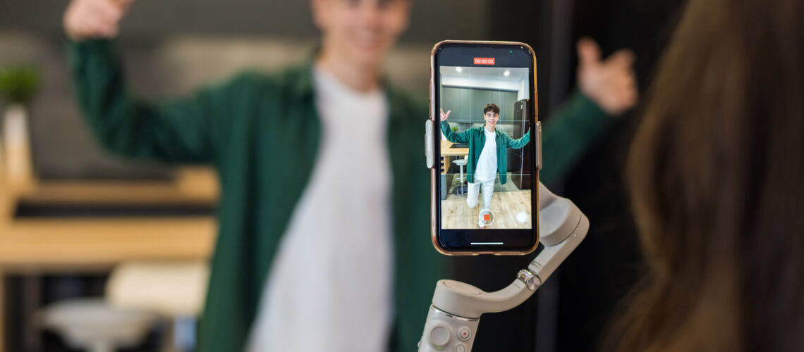 Mädchen filmt mit den Handy einen Jungen